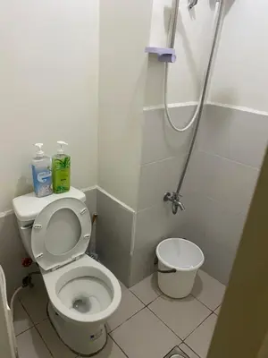 a small bathroom with a toilet and a shower at Pierrecondotel in Manila