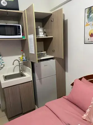 a small kitchen with a sink and a microwave at Pierrecondotel in Manila