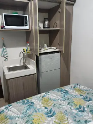 a small kitchen with a sink and a microwave at Nicecondote in Manila