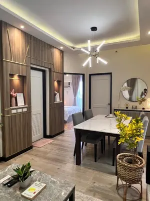 a dining room with a table and a bedroom at 1 Bedroom Penthouse Condo Near Airport NAIA in Manila