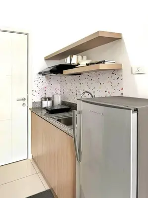 a kitchen with a sink and a refrigerator at 1-Bedroom Condo in Las Piñas in SM SouthMall in Manila