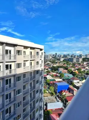 an overhead view of a city with a tall building at 1-Bedroom Condo in Las Piñas in SM SouthMall in Manila
