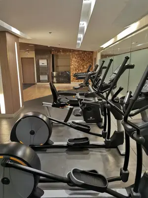 a gym with rows of exercise bikes and mirrors at Mall of Asia Pasay Shore 3 Residence in Manila