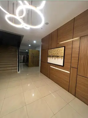 a lobby with wood paneling and a painting on the wall at POEA Mega Mall WiFi Netflix in Manila