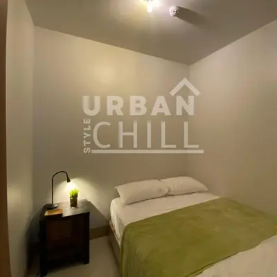a bedroom with a bed and a sign on the wall at Urban Style Chill, Shore 3, MOA Complex, Pasay, Manila in Manila