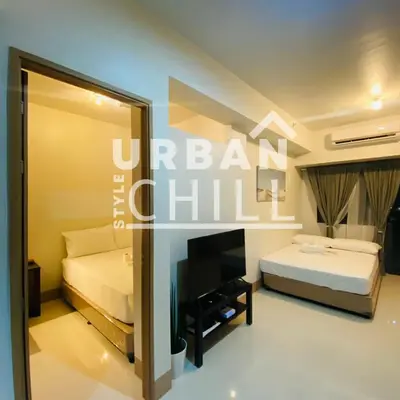 a hotel room with a bed and a mirror at Urban Style Chill, Shore 3, MOA Complex, Pasay, Manila in Manila