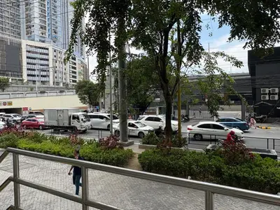 a city street with cars parked in a parking lot at San Lorenzo Place Mall & Residences Tower 3 by Magallanes MRT station Makati in Manila
