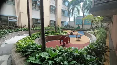 a garden with a playground in a building with plants at Condotels near and across Terminal3 Airport in Manila