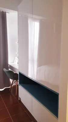 a bedroom with a bed and a desk with a chair at 1BR Cozy Condo at Kasara Urban Resort Pasig City in Manila