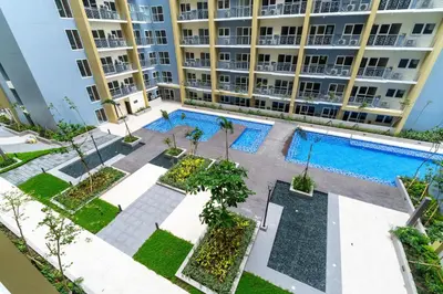 an aerial view of an apartment building with two pools at Ocean View Condo with Infinity Pool, Gym, Spa - Next to Okada, Solaire & MOA in Manila