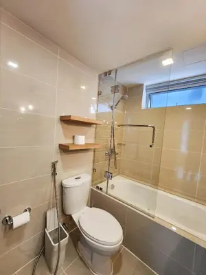a bathroom with a toilet and a bath tub at LUXESTAYSMNL STYLISH FAMILY 2BR SUITE POOLGYM 400MBPS WIFI NETFLX Amazing City View in Manila