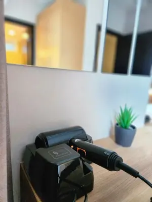 a phone sitting on top of a table at LUXESTAYSMNL STYLISH FAMILY 2BR SUITE POOLGYM 400MBPS WIFI NETFLX Amazing City View in Manila