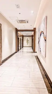 an empty hallway with paintings on the walls at LUXESTAYSMNL Parisian Charm 1BR Suite Pool Gym 400MBPS WiFi Netflix Amazing City View in Manila