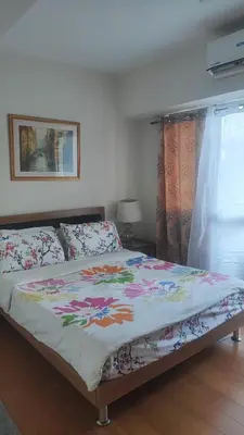 a bedroom with a bed with a colorful comforter at Aveline Suites, Garden City view, 2br, amenities in Manila