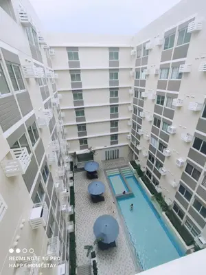 an overhead view of an apartment building with a swimming pool at Happy Homestay at Fullerton Suites Condo near Nuvali and Tagaytay in Silang