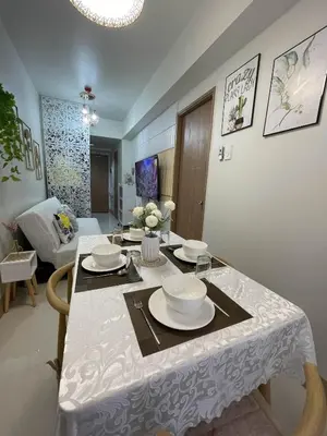 a dining room table with a white table cloth at Molly Shore Getaway Unit 1276 in Manila
