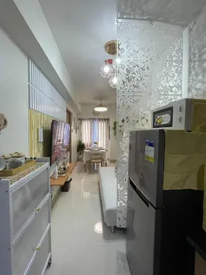 a kitchen with a refrigerator and a living room at Molly Shore Getaway Unit 1276 in Manila