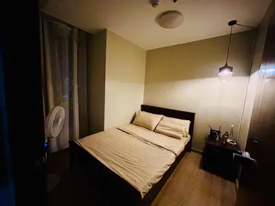 a small bedroom with a bed in a room at Cozy 1BR with BGC View Gym and Pool Included in Manila