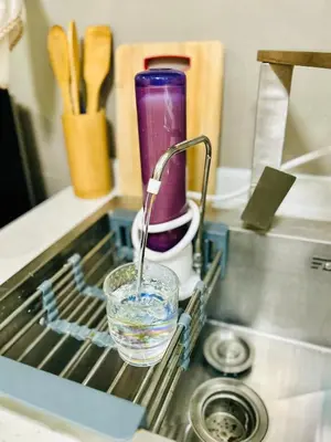 a glass of water is sitting in a drying rack at Cozy 1BR with BGC View Gym and Pool Included in Manila