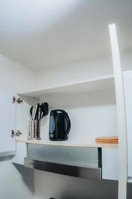 a black appliance sitting on a counter in a kitchen at The House of Five - Brand New Hotel Style Condo in Manila