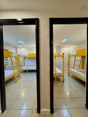two mirrors in a room with bunk beds at Cheese Hostel Manila in Manila