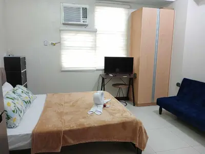 a room with a bed with a stuffed animal on a blanket at Newport 101 - East Wing in Manila