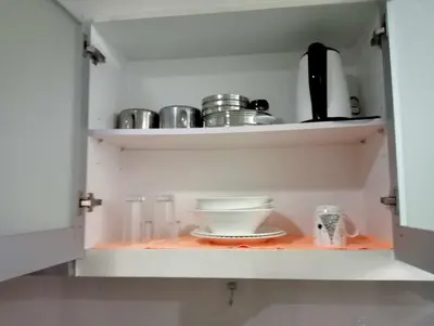 a cupboard with a bowl and dishes on it at Newport 101 - East Wing in Manila