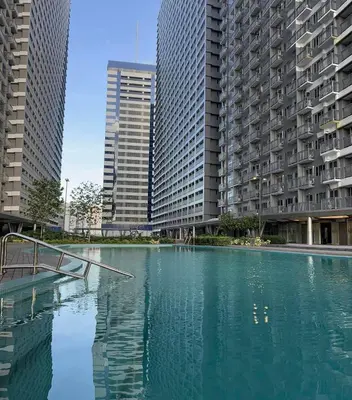 a pool of water in a city with tall buildings at Casa Jezhuel at Fame Residences in Manila