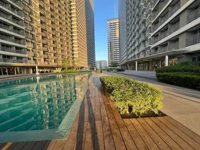 a swimming pool in a city with tall buildings at Casa Jezhuel at Fame Residences in Manila