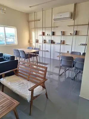 a dining room with tables and chairs and a bench at Cozy Studio Condo Unit at Fullerton Suites in Silang