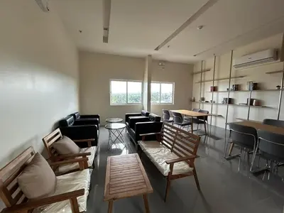 a living room with a couch and chairs and tables at Cozy Studio Condo Unit at Fullerton Suites in Silang