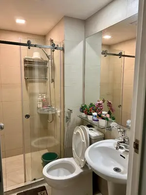 a bathroom with a shower and a toilet and a sink at Azure Urban Beach Residences with PS4 near Airport in Manila