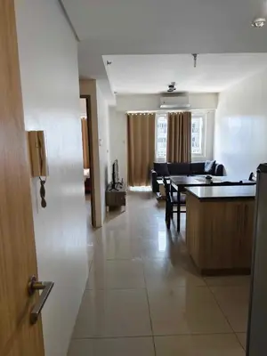 a living room with a table and a dining room at Shore Res 2 Br 2Bath 1417 in Manila