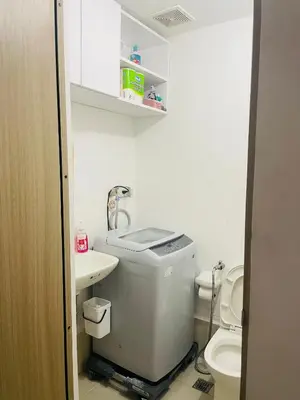 a small bathroom with a toilet and a sink at SMDC Grace Residences in Manila