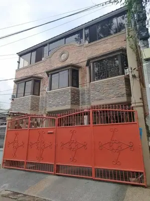 a building with a red gate in front of it at 4-5br Apartment in Paranaque for Staycation in Manila