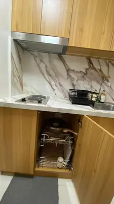a kitchen cabinet with a sink and a dishwasher at Enchanted Gateway by Shore 3 in Manila