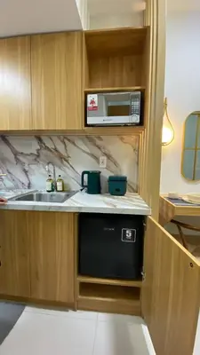 a kitchen with a sink and a microwave at Enchanted Gateway by Shore 3 in Manila