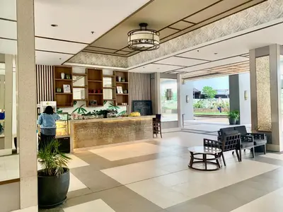 a lobby with a person standing in a kitchen at Rys Sheridan Tower Mandaluyong in Manila