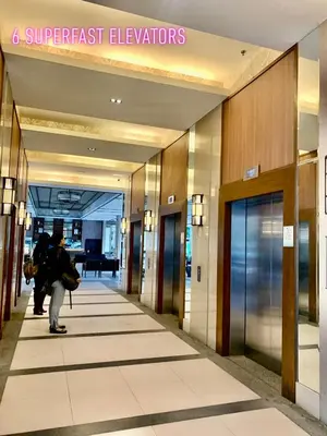 a person walking down a hallway in a building at Rys Sheridan Tower Mandaluyong in Manila