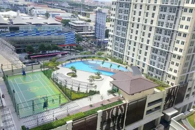 an aerial view of a tennis court in a city at Cozy 2BR 2Bath San Lorenzo Place Netflix 4KM NAIA in Manila