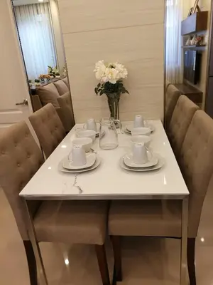 a white table with cups and saucers on it at Adria Residences - Diamond Garden - 2 Bedroom Unit for 4 Person in Manila