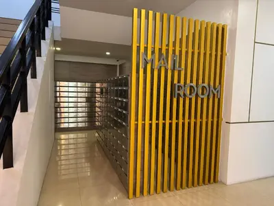 a lobby with a yellow wall with the name of a room at AMA Tower Studio, 8th flr, near DMW and SM Megamall in Manila