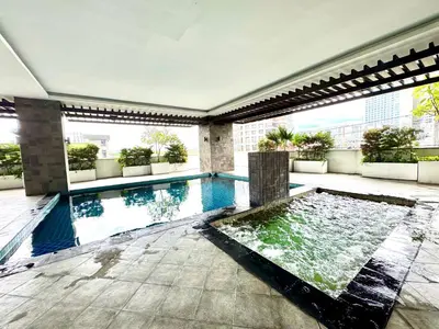 a swimming pool in the middle of a building at AMA Tower Studio, 8th flr, near DMW and SM Megamall in Manila