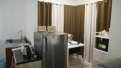 a kitchen with a stainless steel refrigerator and a desk at Experience Santa Rosa Comfort at MEGAN Montagne Suite in Santa Rosa