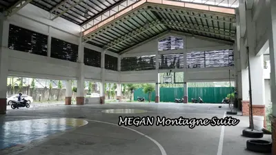 a large building with a basketball court and a man on a motorcycle at Experience Santa Rosa Comfort at MEGAN Montagne Suite in Santa Rosa