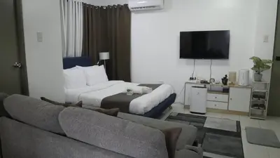 a living room with a bed and a couch at Experience Santa Rosa Comfort at MEGAN Montagne Suite in Santa Rosa