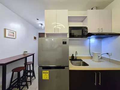 a kitchen with a stainless steel refrigerator and a counter at 1BR Condotel Ridgewood Towers Taguig City #RW02 in Manila