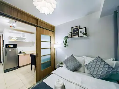 a living room with a bed and a kitchen at 1BR Condotel Ridgewood Towers Taguig City #RW03 in Manila