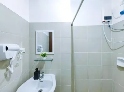 a white bathroom with a sink and a shower at 1BR Condotel Ridgewood Towers Taguig City #RW03 in Manila