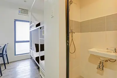 a bathroom with a sink and a shower at Spot On Classy Bunkbeds Near Makati Manila Formerly MYTOWN Madrid in Manila